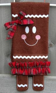 a brown christmas stocking with a red plaid bow and smiling face on the front