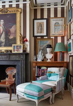 a living room filled with furniture and pictures on the wall above a fire place in front of a fireplace