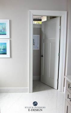 an open door leading to a bathroom with pictures on the wall