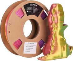 a spool of pink and yellow filament next to a spool of orange