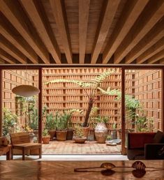 an open room with wooden walls and plants