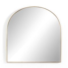 an arch shaped mirror on the wall