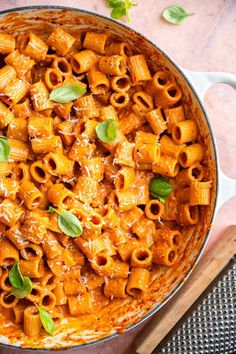 a pot filled with pasta and sauce on top of a table