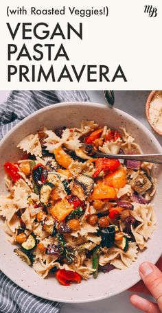 a white bowl filled with pasta and vegetables