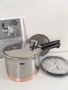 a pot and saucer sitting on a counter top