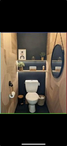 there is a small bathroom with wood paneling on the walls and a white toilet