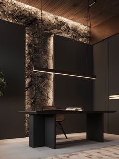 a black table and chair in a room with dark walls, wood ceiling and lighting