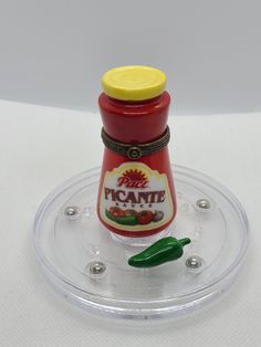 there is a small plastic container with some food on it and a green pepper in the middle