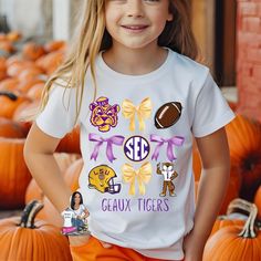 This Personalized  LSU Coquette Shirt will be just adorable on any fan, faculty, staff, or alumni! This design will be sure to turn heads! This is a direct to film print pressed onto a shirt. YOUTH Unisex gildan tshirt. True to size. Please visit shop for adult sized  Orders are shipped in 3 Business Days and may take an additional 3-7 business days to arrive! Please contact me if you need an order sooner. White Mascot T-shirt For Football Season, School Spirit White T-shirt With Mascot, White School Spirit T-shirt With Mascot, White Mascot T-shirt For Game Day, White Sports Fan T-shirt With Mascot, White T-shirt With School Spirit Mascot, White Mascot T-shirt For Fan Gear, White Collegiate Mascot T-shirt, College Mascot T-shirt For Football Season