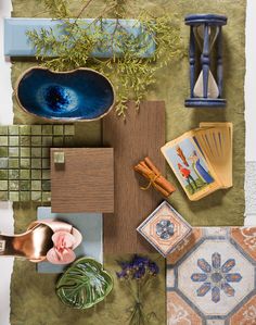 an assortment of decorative items displayed on top of a green surface with blue and gold accents