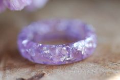 a purple ring sitting on top of a wooden table