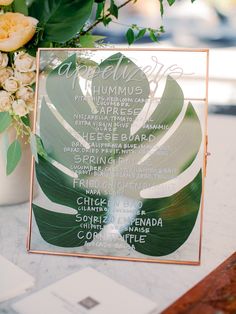 a table with a menu and flowers on it