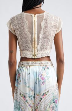 A faded floral print lends a vintage-inspired feel to this cropped silk top designed with corset-inspired cups and crystal-embellished lace. 15" length (size Medium) Exposed back-zip closure Jewel neck Cap sleeves Partially lined 100% silk with 100% nylon contrast Dry clean Imported Designer Clothing Lace Patchwork Crop Top, Fitted Lace Patchwork Crop Top, Fitted Lace Crop Top For Festival, Fitted Crop Top With Lace Patchwork, Fitted Cropped Crop Top With Lace Patchwork, Fitted Lace Trim Crop Top For Festival, Fitted Crop Top With Lace Trim For Festival, Bohemian Lace Trim Crop Top For Festivals, Bohemian Crop Top With Lace Trim For Festivals