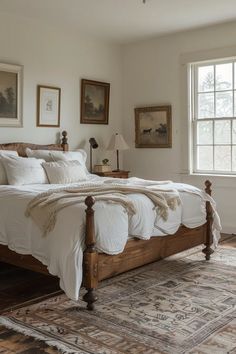 a large bed sitting in a bedroom next to a window