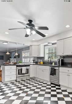 a black and white checkered floor in a kitchen with a ceiling fan above the stove