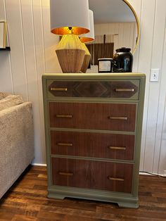 an old dresser has been painted green and gold