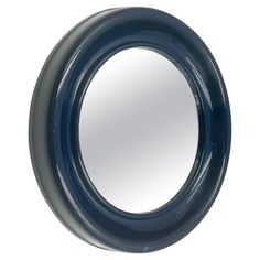 a round mirror is shown against a white background