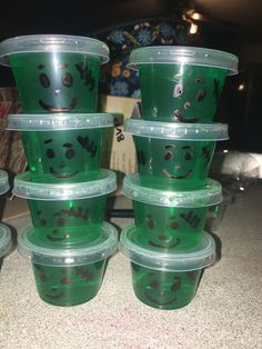 there are many plastic cups with faces on them