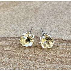 Reflecting a bright yellow tone with a rooted in earthen brown, this stone adds a solar palette to your outfit, recalling a midsummer carefree attitude any time of year. This art jewelry is perfect for everyday wear or as a twinkling, crystalline addition to formalwear. Sometimes recognized as the November birthstone, these studs are a perfect birthday gift. faceted citrine, 5mm rounds, about 1.1 tcw sterling stud ear posts includes sterling and plastic ear nuts Elegant Yellow Birthstone Earrings, Classic Yellow Citrine Earrings, Classic Yellow Earrings As Gift, Classic Yellow Earrings For Gift, Classic Citrine Earrings For Gift, Classic Citrine Earrings As Gift, Classic Citrine Earrings, Yellow Citrine Jewelry With Prong Setting, Yellow Citrine Earrings With Prong Setting