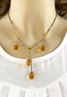 Lovely vintage 1920s Art Deco faceted citrine-colored glass with matching enamel work in silver-tone sautoir necklace. Measures - 15 inches long, 38.10 cm CONDITION: Great. See pics for details. If you like what you see here please take the time to check out the other vintage Art Deco jewelry I have for sale. I combine shipping costs for multiple purchases. Vintage Briolette Necklace For Formal Occasions, Art Deco Beaded Jewelry For Formal Occasions, Gold Drop Vintage Necklace, Vintage Gold Drop Necklace, Vintage Briolette Gemstone Jewelry, Vintage Faceted Sterling Silver Jewelry, Elegant Amber Necklace Nickel Free, Vintage Gold Briolette Necklace, Vintage Glass Necklace Nickel Free