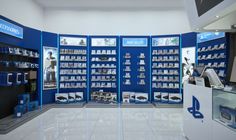 the inside of an electronics store with blue walls and shelves filled with electronic devices on display