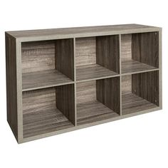 an open bookcase with four compartments on the front and one section in grey wood