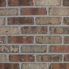 an old brick wall that has been painted red