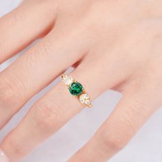 Make your style known with our breathtaking Ada emerald ring. Made on a base of Sterling Silver 925 and finished with a beautiful center emerald, this bold contrast will add a unique luxury to any outfit. Plus, our gorgeous CZ crystals further accentuate the shine, giving you a design you’ll simply adore. ✦ DETAILS ✦✧ Handcrafted ✧ 0.75 Carat center stone✧ Emerald and cz crystals ✧ Sizes 3.5-11✧ Rose gold over sterling silver 925, gold over sterling silver 925, or sterling silver 925 Classic Green Jewelry For Promise Occasions, Emerald Solitaire Ring For May Birthstone, May Birthstone Emerald Solitaire Open Ring, Fine Jewelry Emerald Ring With Center Stone For Promise, Fine Jewelry Emerald Promise Ring With Center Stone, Green Emerald Ring With Accent Stones For May Birthstone, Classic Emerald Ring For Promise, Elegant Emerald Ring With Center Stone, Elegant Green Round Cut Ring