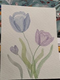 watercolor painting of purple flowers on white paper