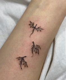 three bats tattoo on the left arm