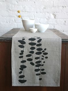 two bowls are sitting on a table with a black and white cloth draped over it