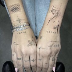 two people with matching tattoos on their hands