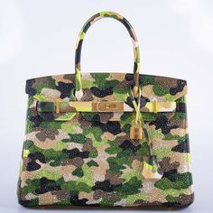 This Hermès Customized Swarovski Crystal Camo Birkin 30 is a vibrant tapestry of opulence and artistry, its green Togo leather canvas intricately bedecked with shimmering crystals that form an avant-garde camouflage pattern. Each Swarovski crystal is meticulously placed, creating an armor of splendor that catches light and attention alike, while the gold hardware adds a statement of undoubted opulence. This Hermès Birkin is not just a bag, but a wearable piece of art. It transcends the boundarie Camouflage Art, Vintage Kelly, Dream Bags, Hermes Kelly Bag, Birkin 30, Girl Dinner, Togo Leather, Kelly Bag