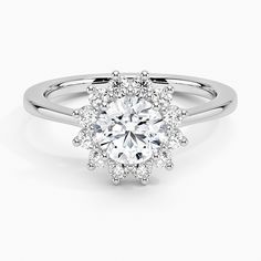 a white gold engagement ring with an oval center surrounded by round diamonds