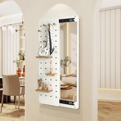 a white clock mounted to the side of a wall next to a dining room table