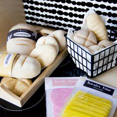 there are some breads in the basket on the table next to other food items