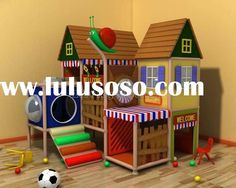 a child's play house with toys and balls on the floor in front of it