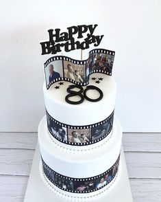 a birthday cake decorated with photos and the number 80 on it's top tier