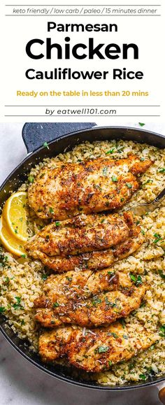 chicken cauliflower rice in a skillet with lemon wedges