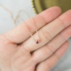 "14k solid rose gold dahlia setting floating ruby necklace. This setting is my signature style using milgrain frame to add a bit of antique taste to the simple and subtle necklace. It is so lightweight, perfect everyday piece. This ruby has a lot of sparkles and with a deep wine red hue. Purchase this beautifully handcrafted necklace for special occasions such as birthdays, anniversaries, holidays, Mother's Day, Valentine's Day, or even for bridesmaids! * Sold as one necklace * Setting size: 2mm Dainty Ruby Gemstone Birthstone Necklace, Minimalist Ruby Birthstone Necklace, Rose Gold Ruby Birthstone Necklace, Dainty Ruby Birthstone Necklace, Ruby Necklace With Bezel Setting As Gift, Delicate Rose Gold Round Pendant Birthstone Necklace, Rose Gold Ruby Necklace For Gift, Dainty Round Ruby Necklaces, Dainty Round Ruby Necklace