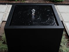 a black box with water in it on the ground