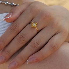 Our Eight Point Star Open Ring celebrates the beauty of life - rich or poor. Crafted with care, this stunning piece of jewelry is symbolic of our journey and the wisdom we possess along the way. Sparkling with meaning! Metal: 18K Gold over Stainless Steel Hypoallergenic & Water Resistant Size: Adjustable Yellow Gold Star-shaped Promise Jewelry, Star-shaped Gemstone Rings For Gifts, Star-shaped Birthstone Promise Ring, Fine Jewelry Star Shaped Rings For Gifts, Fine Jewelry Star-shaped Ring For Gift, Yellow Gold Star-shaped Gemstone Ring, Yellow Gold Spiritual Promise Ring, Yellow Gold Spiritual Crystal Promise Ring, Spiritual Yellow Gold Crystal Promise Ring