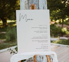 a menu sitting on top of a wooden table next to a white canvas covered bag