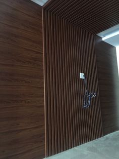 an electrical outlet is plugged into the wood paneled wall in this modern room