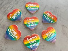 six heart shaped cookies with the words i love you in different languages on them, all decorated to look like rainbows