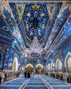 the interior of an ornate building with blue and gold tiles