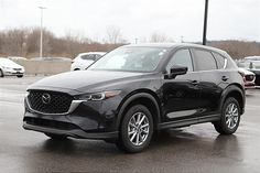 a black mazda cx - 5 parked in a parking lot