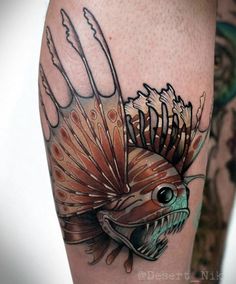 a fish with feathers on it's head is shown in this tattoo art design