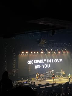 an image of a band on stage with the words god is madly in love with you