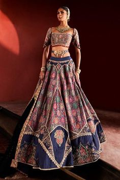 This chic dark blue jamawar lehenga set is an exquisite embodiment of timeless elegance. The square neckline blouse features intricate hand-embroidered zari work, complemented by delicate pearls and geometric latkans, seamlessly blending tradition with modern flair. The flowing jamawar skirt showcases stunning embroidered appliqué and vibrant bead details, while the opulent zari border adds a touch of grandeur. Finished with a meticulously handcrafted belt to define the waist, this luxurious masterpiece is perfect for those who cherish the finer things in life, making it an impeccable choice for any grand occasion. Elegant Fitted Sharara With Meenakari, Elegant Meenakari Lehenga In Traditional Drape, Elegant Meenakari Lehenga With Traditional Drape, Elegant Fitted Anarkali Set With Meenakari, Elegant Fitted Lehenga With Meenakari Detailing, Elegant Meenakari Lehenga, Elegant Semi-stitched Lehenga With Meenakari Details, Elegant Fitted Meenakari Choli, Elegant Lehenga With Motifs For Navratri